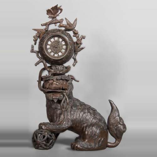 Chinese style clock with Foo dog decoration.