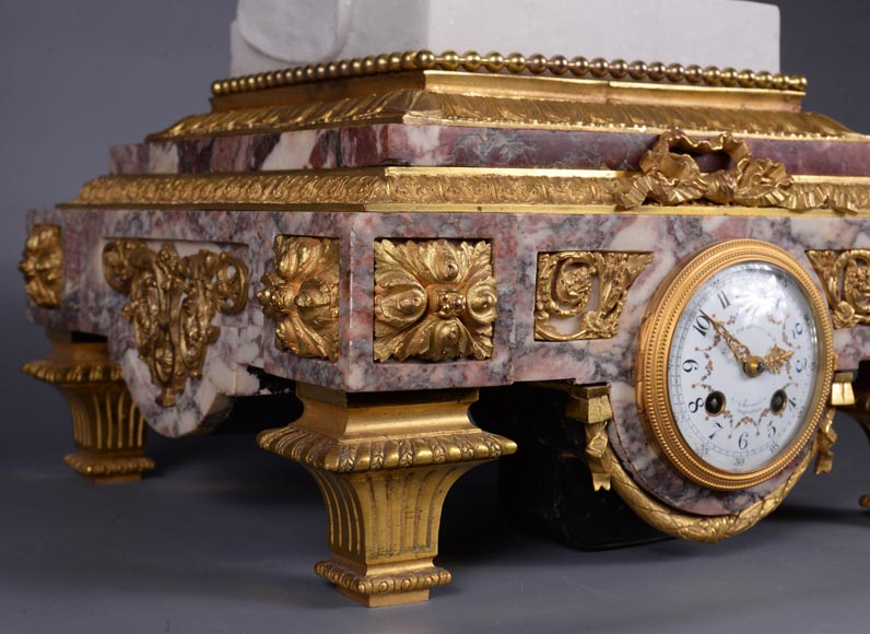Peach blossom marble and gilt bronze clock surmounted by a statuary white marble sculpture representing Phryne in front of his judges signed Peach blossom marble and gilt bronze clock surmounted by a statuary white marble sculpture representing Phryne in front of his judges signed
