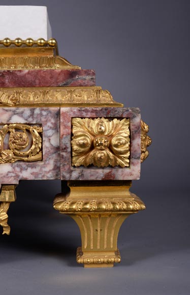 Peach blossom marble and gilt bronze clock surmounted by a statuary white marble sculpture representing Phryne in front of his judges signed Peach blossom marble and gilt bronze clock surmounted by a statuary white marble sculpture representing Phryne in front of his judges signed