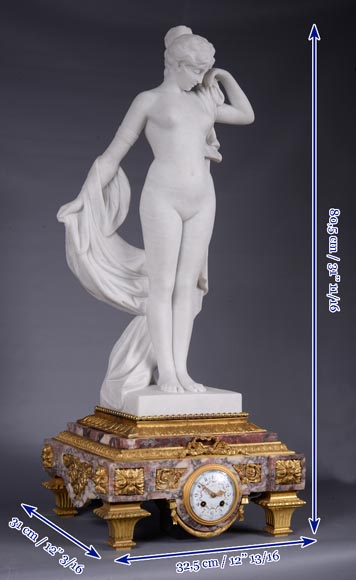 Peach blossom marble and gilt bronze clock surmounted by a statuary white marble sculpture representing Phryne in front of his judges signed Peach blossom marble and gilt bronze clock surmounted by a statuary white marble sculpture representing Phryne in front of his judges signed