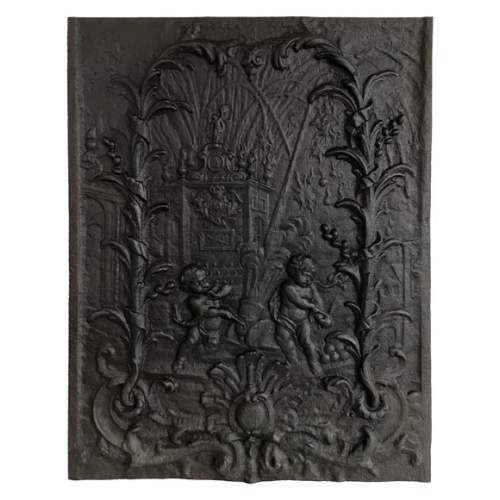 Cast iron fireback with putti firing a cannon