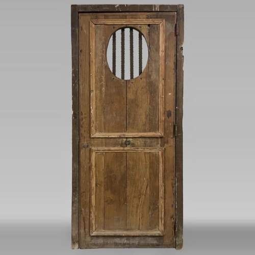 Small antique and simple door in oak with an oval opening