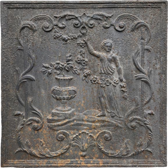 18th century fireback representing a female figure with a flower garland next to an antique vase 18th century fireback representing a female figure with a flower garland next to an antique vase-0