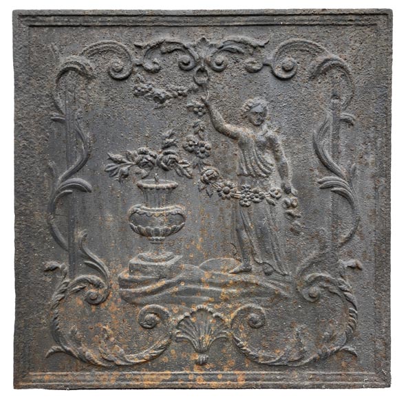 18th century fireback representing a female figure with a flower garland next to an antique vase 18th century fireback representing a female figure with a flower garland next to an antique vase-1