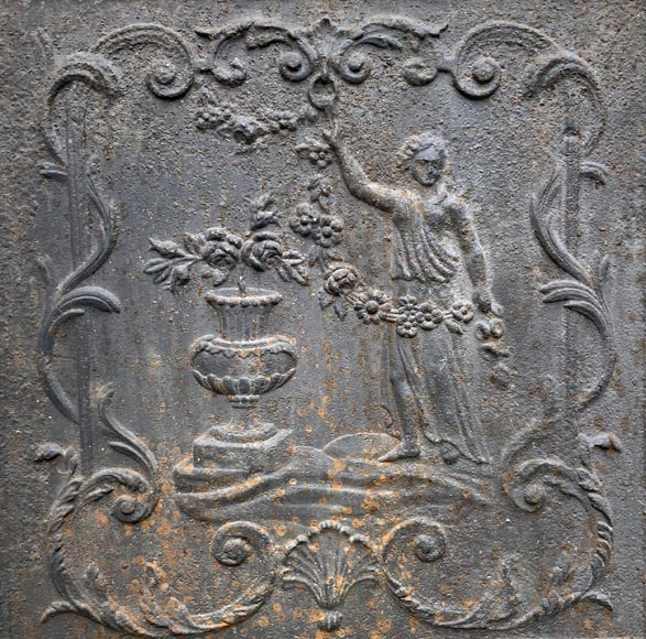 18th century fireback representing a female figure with a flower garland next to an antique vase 18th century fireback representing a female figure with a flower garland next to an antique vase-2