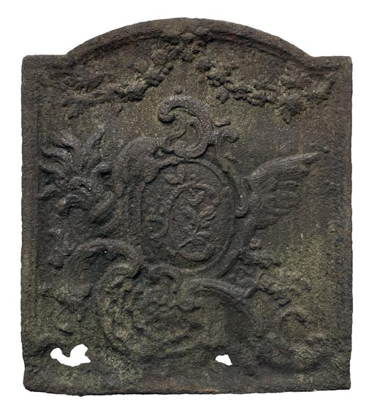 Small fireback in the Louis XV style, decorated with a medallion featuring an illuminated C. Small fireback in the Louis XV style, decorated with a medallion featuring an illuminated C.-0