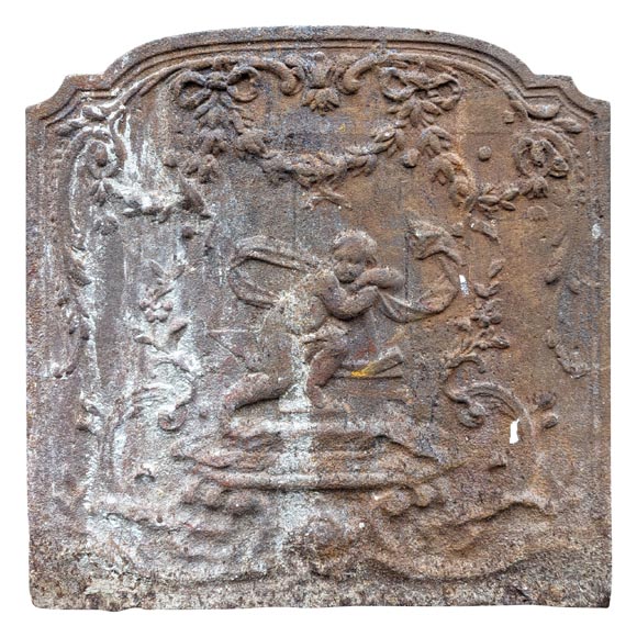 Fireback from the 19th century in the Louis XV style with the Fireback from the 19th century in the Louis XV style with the