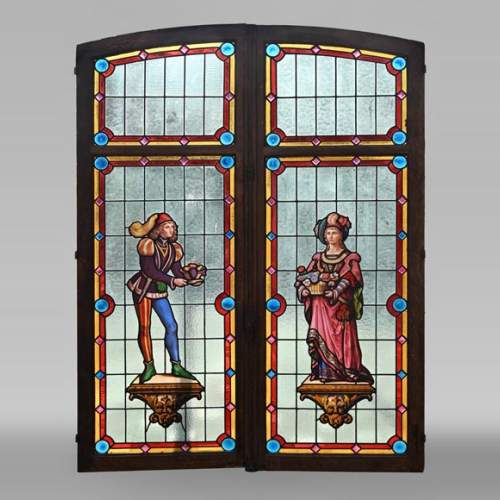 Double stained glass window in neo-Renaissance style depicting two figures with offerings