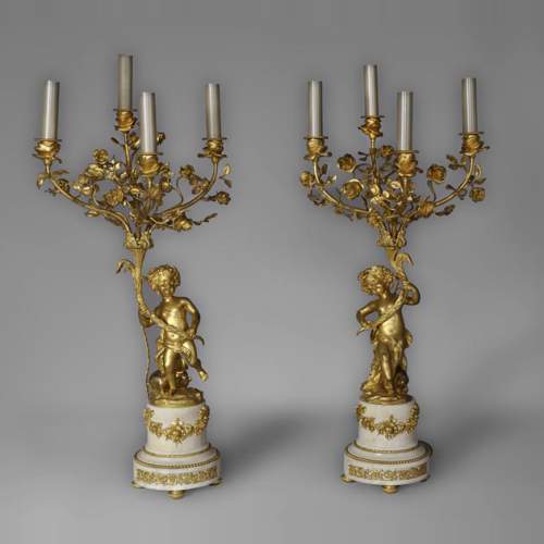 Beautiful antique pair of candelabras made out of Statuary Carrara marble and gilded bronze with putti and roses decor