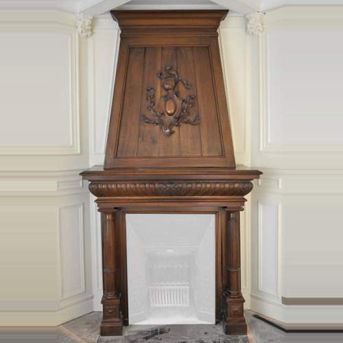 Large antique Neo-Renaissance style fireplace made out of carved walnut with Helm Knight decor