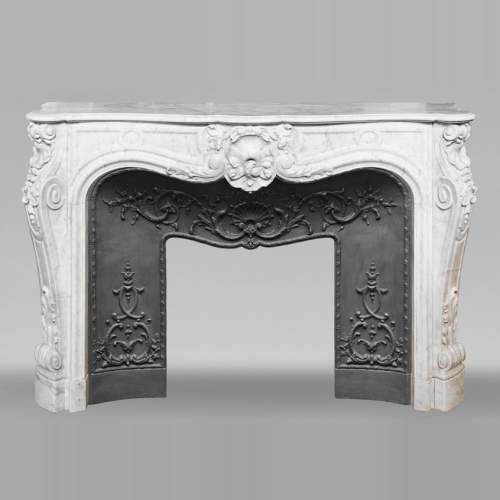 Louis XV style fireplace in Carrara marble, richly decorated with shells and flowers