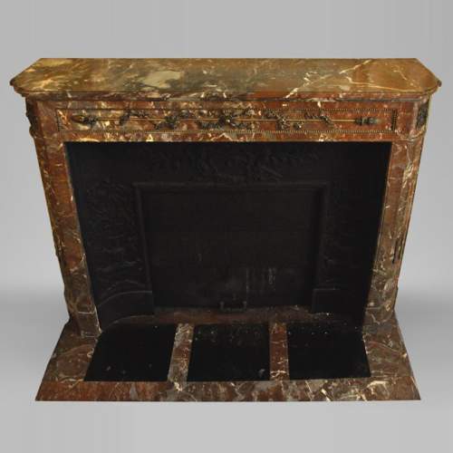Antique Louis XVI style fireplace with round corners in Red from the North marble and gilded bronze ornaments