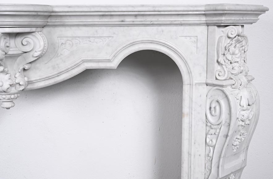 A richly sculpted Carrara marble fireplace in the Napoleon III style, decorated with a lion's head. A richly sculpted Carrara marble fireplace in the Napoleon III style, decorated with a lion's head.-9