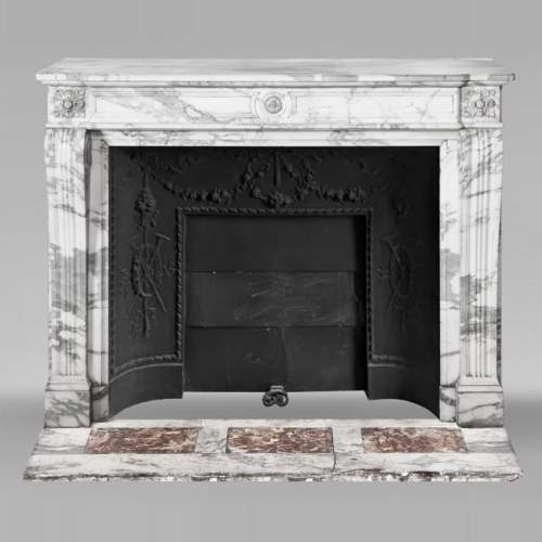Louis XVI style fireplace decorated with a sunflower, in Arabescato marble