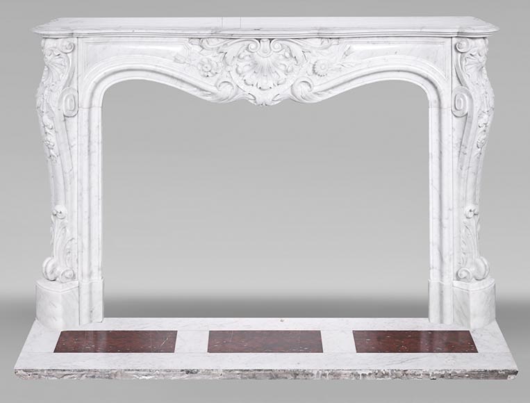 A highly sculpted Louis XV style fireplace in Carrara marble, decorated with a shell motif. A highly sculpted Louis XV style fireplace in Carrara marble, decorated with a shell motif.-0
