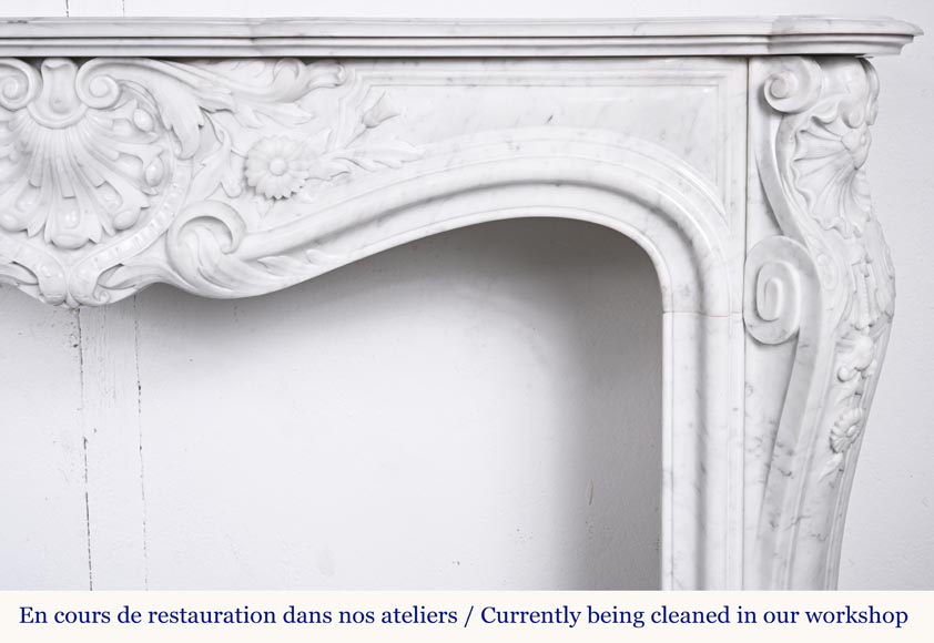 A highly sculpted Louis XV style fireplace in Carrara marble, decorated with a shell motif. A highly sculpted Louis XV style fireplace in Carrara marble, decorated with a shell motif.-11