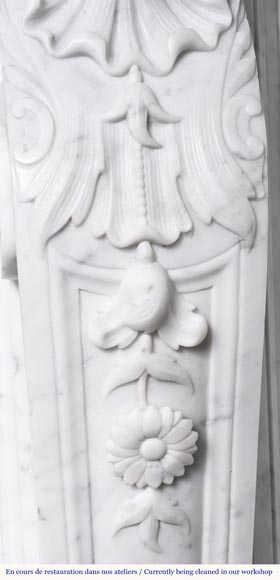 A highly sculpted Louis XV style fireplace in Carrara marble, decorated with a shell motif. A highly sculpted Louis XV style fireplace in Carrara marble, decorated with a shell motif.-12