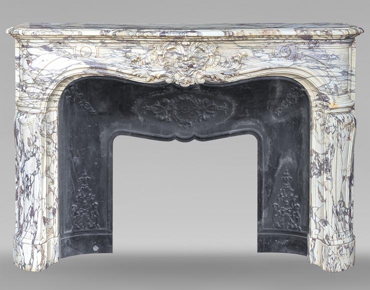 Large Regency-style mantel richly carved in violet breche marble Large Regency-style mantel richly carved in violet breche marble-0