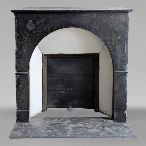 Restoration period arched mantel in black spotted marble