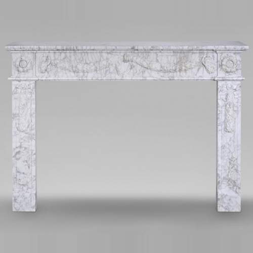 Louis XVI period mantel adorned with a garland carved in antique veined Carrara marble