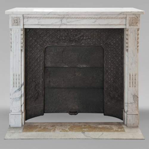Louis XVI style mantel with pilaster feet carved in veined Carrara marble