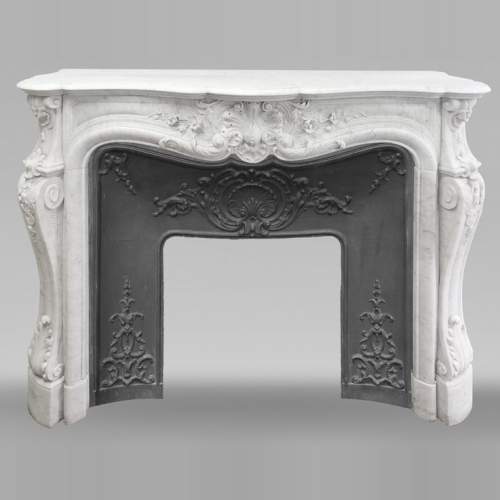 Louis XV style fireplace in Carrara marble, decorated with a floral shell