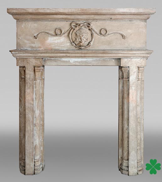 Carved stone fireplace with three-faced mask decoration-0