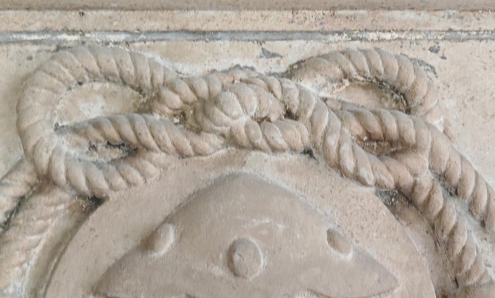 Carved stone fireplace with three-faced mask decoration-3