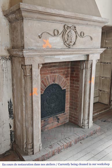 Carved stone fireplace with three-faced mask decoration-4