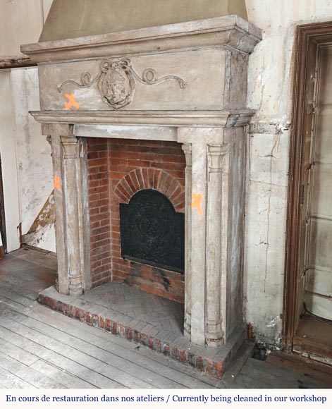 Carved stone fireplace with three-faced mask decoration-5