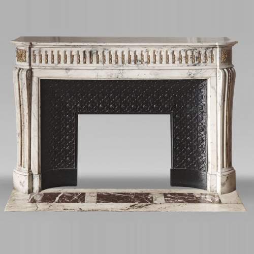 Curved Louis XVI style fireplace in veined marble, with bronze asparagus decoration