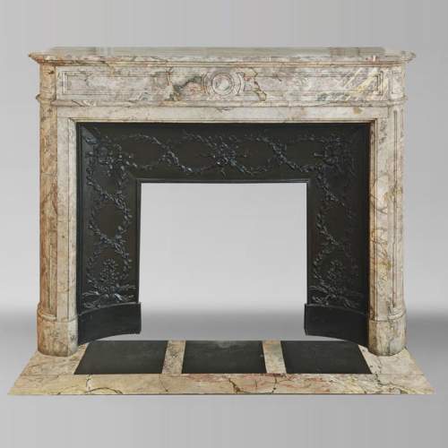 Louis XVI style fireplace with rounded corner, in Sarrancolin marble