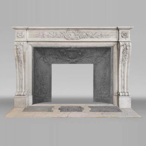 Louis XVI style fireplace in highly sculpted Carrara marble with floral decoration