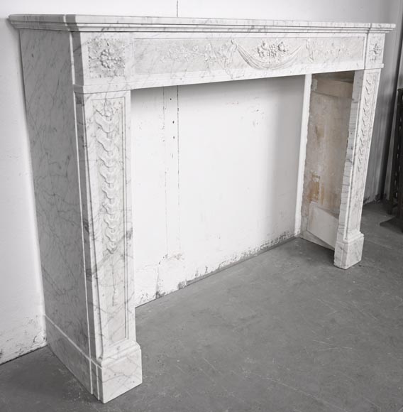 Louis XVI period fireplace with carved fruit decoration, in veined Carrara marble-5