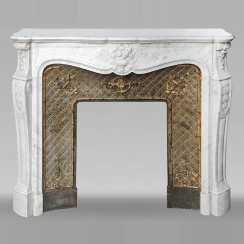 Louis XV style fireplace in Carrara marble, decorated with a vase of flowers