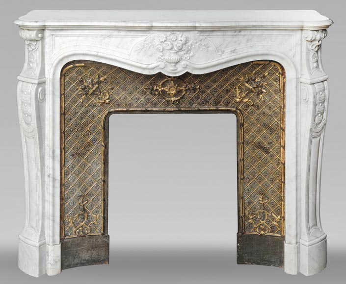 Louis XV style fireplace in Carrara marble, decorated with a vase of flowers Louis XV style fireplace in Carrara marble, decorated with a vase of flowers-0
