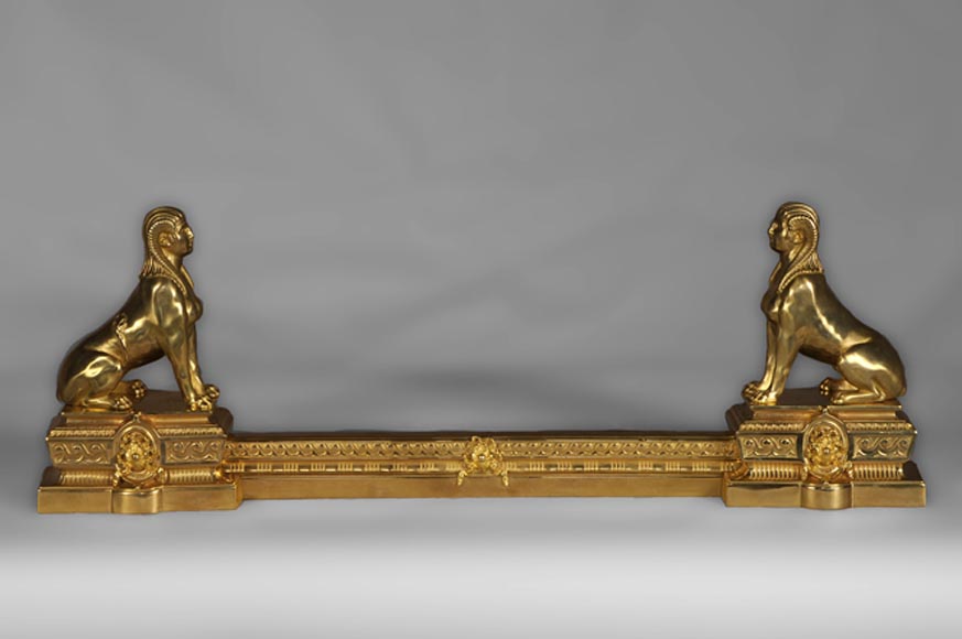 Antique firedog with sphinges decoration in golden bronze Antique firedog with sphinges decoration in golden bronze-0
